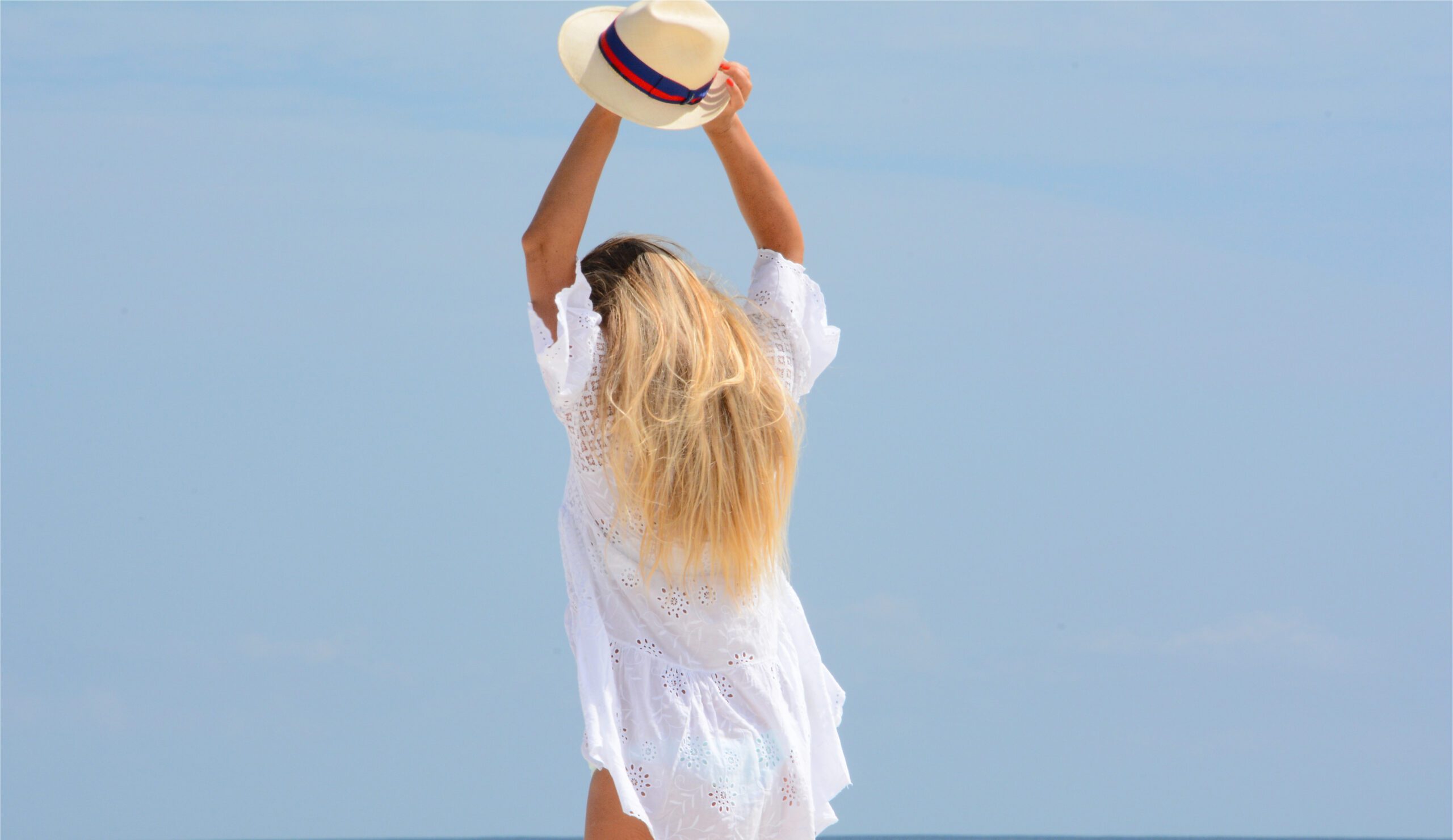 Tantra Girl posing with a stylish cap during a sunny day