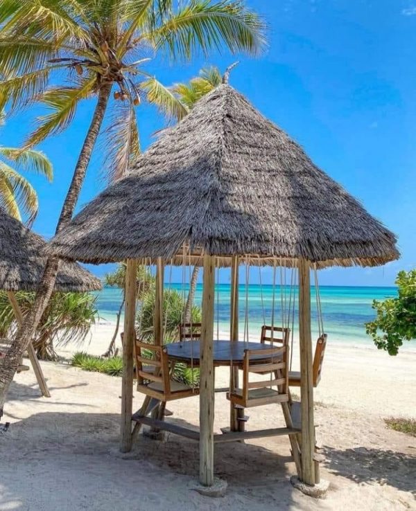 Tantra Seating rugs laid out with a beautiful beach view