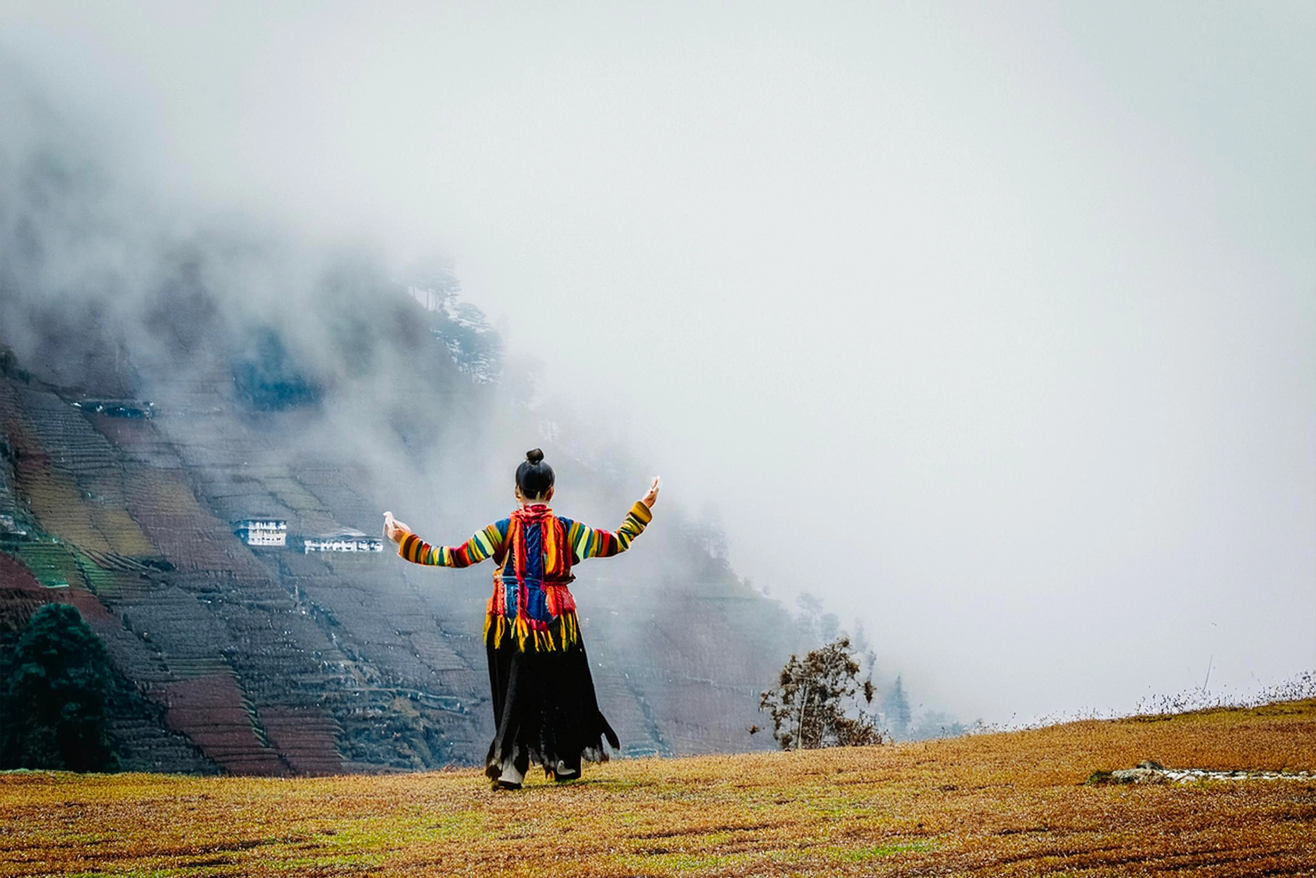 A breathtaking view of Bhutan’s iconic Tiger’s Nest Monastery, perched on a cliffside, surrounded by lush green forests and rugged mountains. The image captures the spiritual and natural beauty of Bhutan, symbolizing its harmonious blend of spirituality and nature