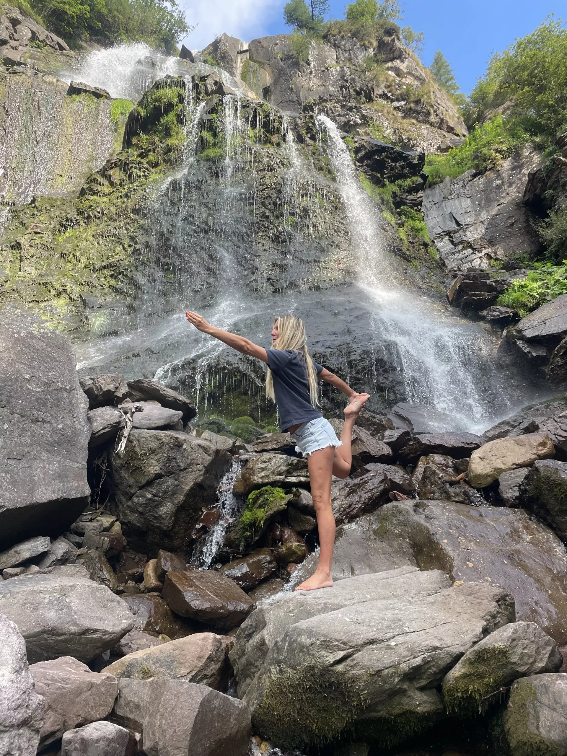 Serene outdoor setting with calm water and a person practicing yoga, highlighting the deep relaxation and inner peace achieved through the combination of yoga and water meditation