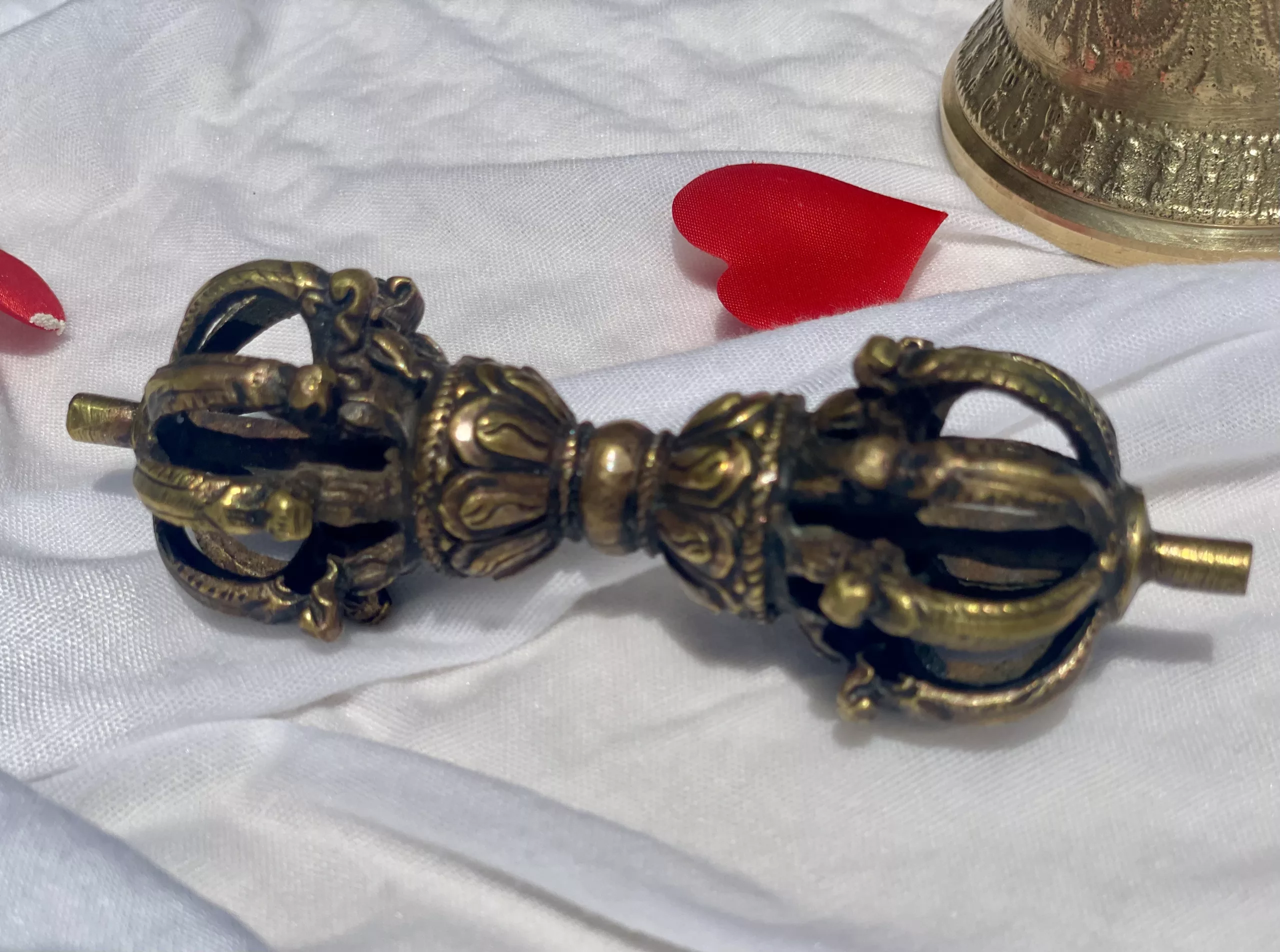 A Vajra with a bell and a red heart, symbolizing the union of strength, clarity, and love in overcoming the ego
