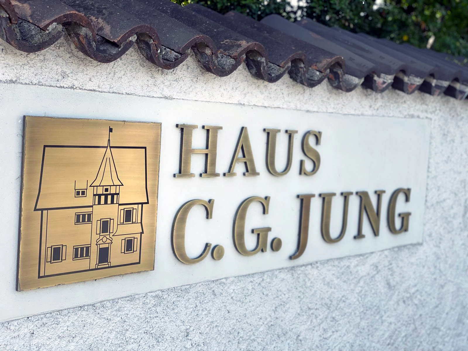 Tantra The entrance to the Carl Gustav Jung Museum House in Küsnacht, with the name of the house visible on the stone facade — a silent threshold into the soul of the man who mapped the unconscious.