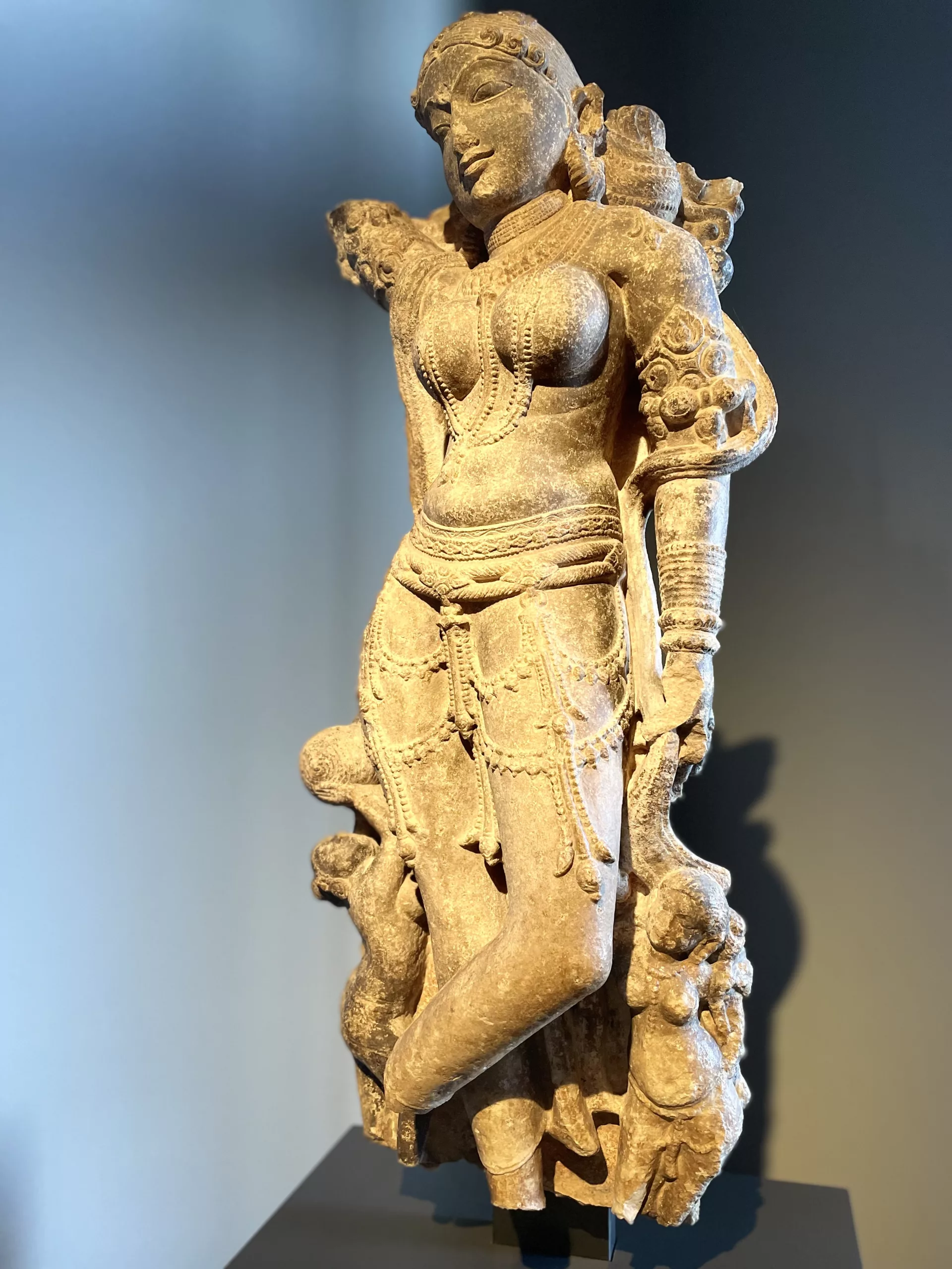 A serene statue of Maha Mata, the Great Mother, surrounded by lush greenery, embodying the silent wisdom and nurturing presence of nature’s voice