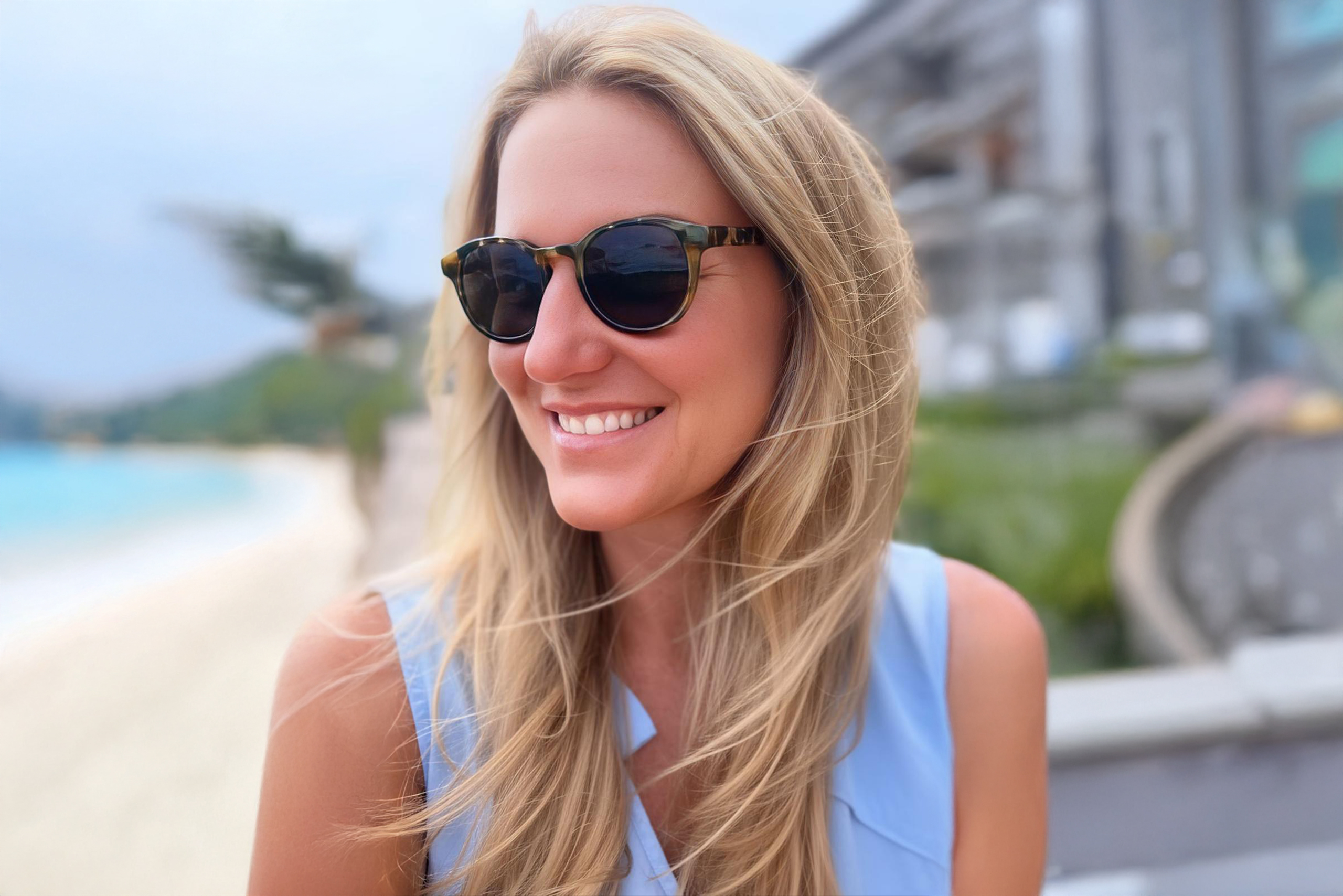 Smiling woman relaxing on the beach, enjoying the sun and the sea, symbol of joy and inner well-being